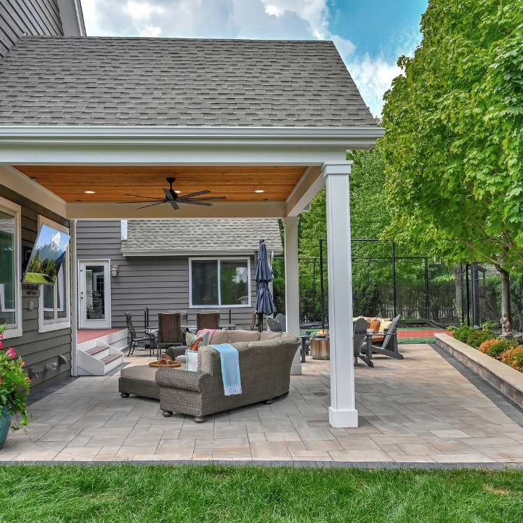 Covered Patio Provides Beautiful Outdoor Entertaining Space by J&J Construction